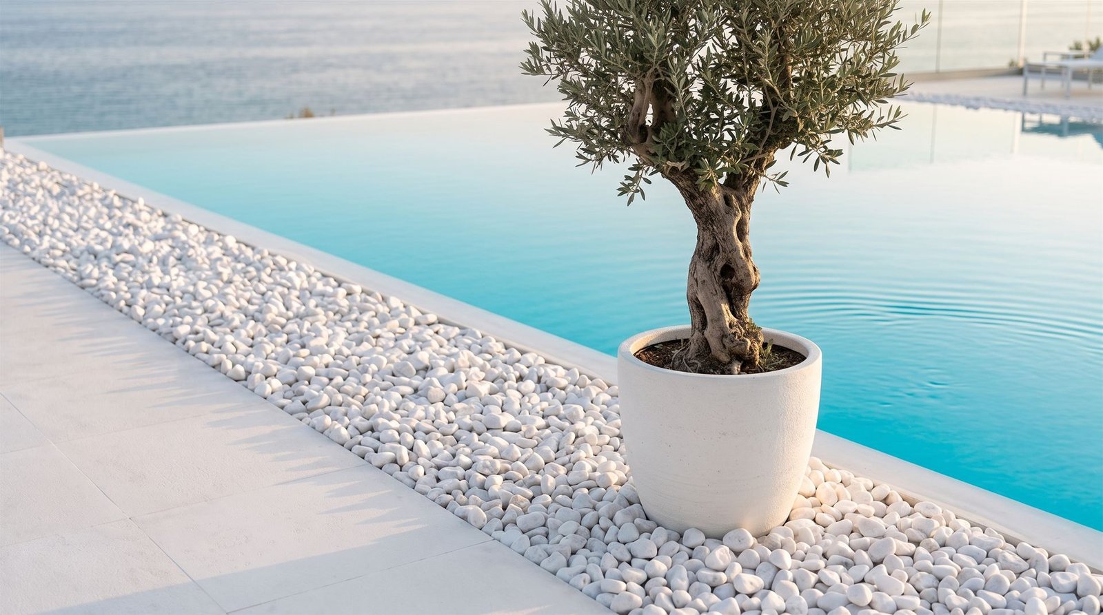 Snow white pebbles bordering an infinity pool