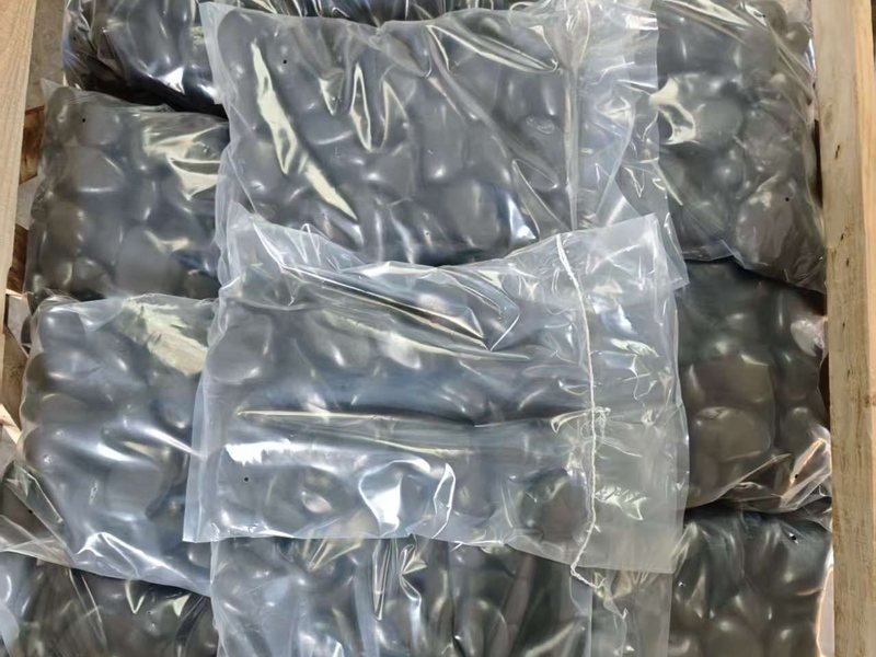 Black polished pebbles packed for export from China