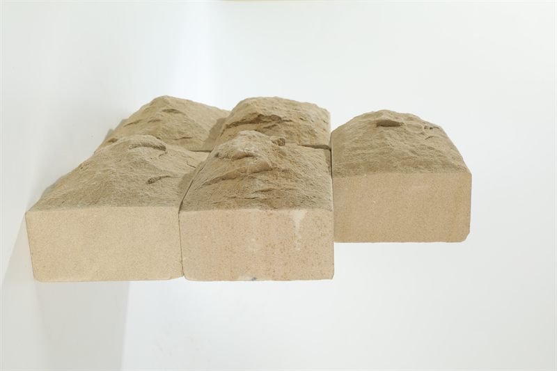 Beige sandstone bricks — mushroom face showing surface texture