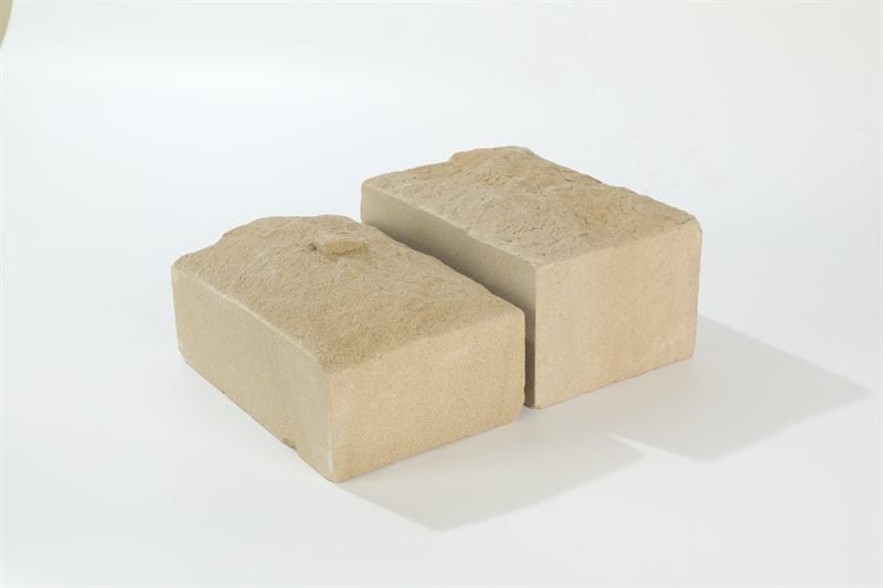 A loose quantity of beige sandstone bricks — mushroom face