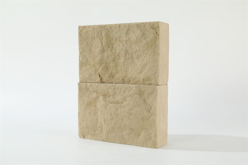 Beige sandstone bricks — natural face showing surface texture