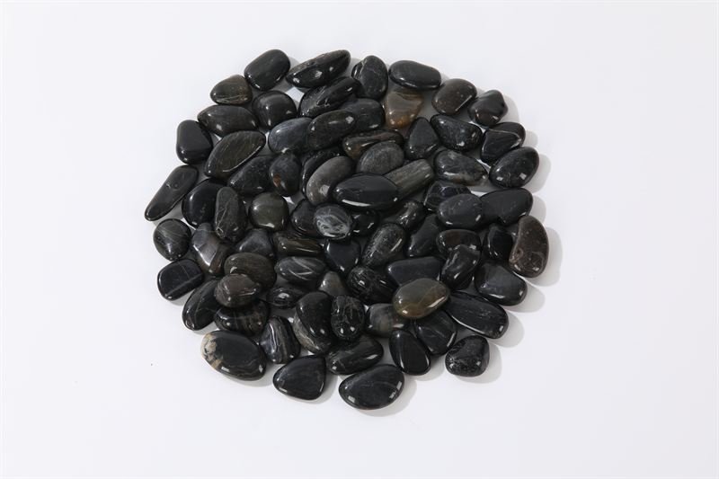 Natural black polished pebbles shown in closer detail