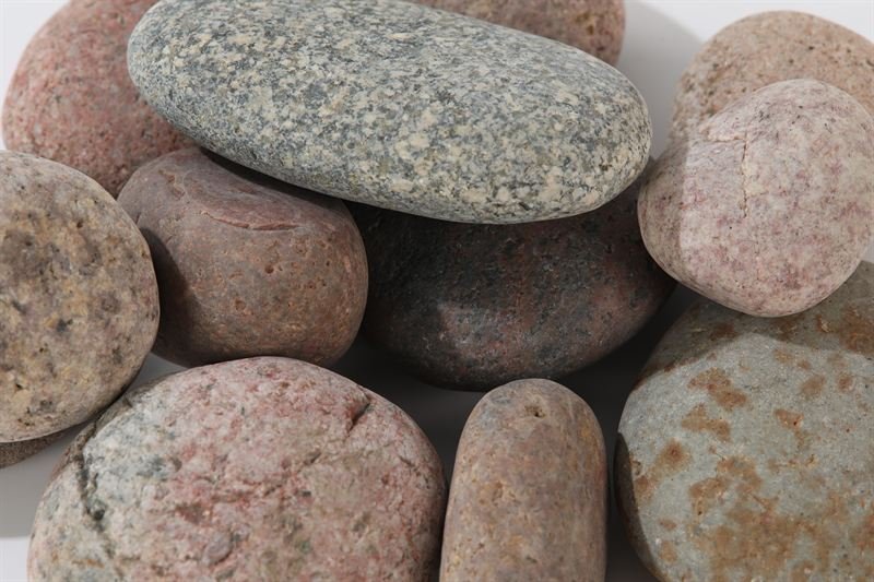 Rainbow coloured pebbles showing surface texture