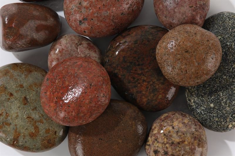 Rainbow coloured pebbles showing natural colour and shape variation