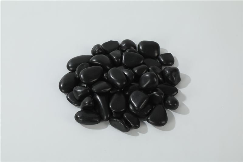 Black polished pebbles in 20–30mm showing natural shape variation