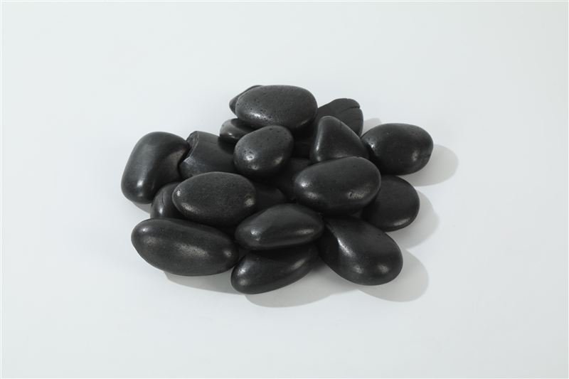 Close-up of black polished pebbles in 30–50mm