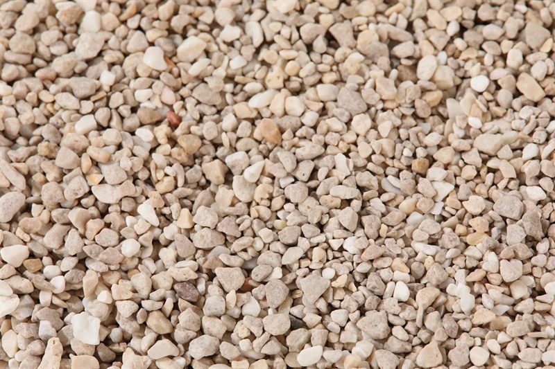 Beige crushed aggregate in 2–5mm showing colour range