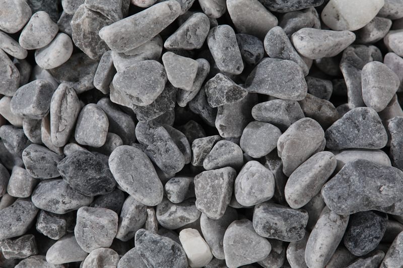 Dark grey rounded gravel in 10–20mm showing natural shape variation
