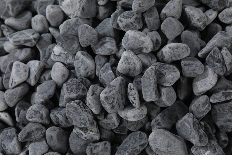 Dark grey rounded gravel in 10–20mm showing surface texture