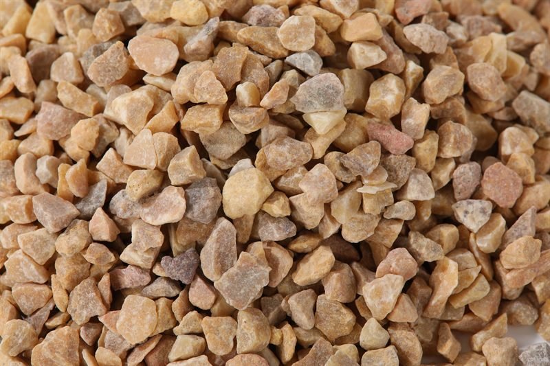 Gold yellow crushed aggregate in 5–15mm showing natural shape variation