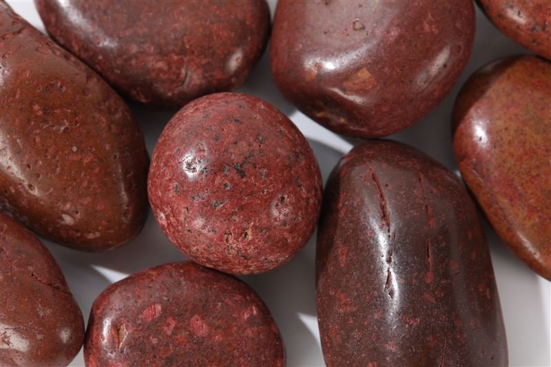 Red high polished pebbles shown in closer detail