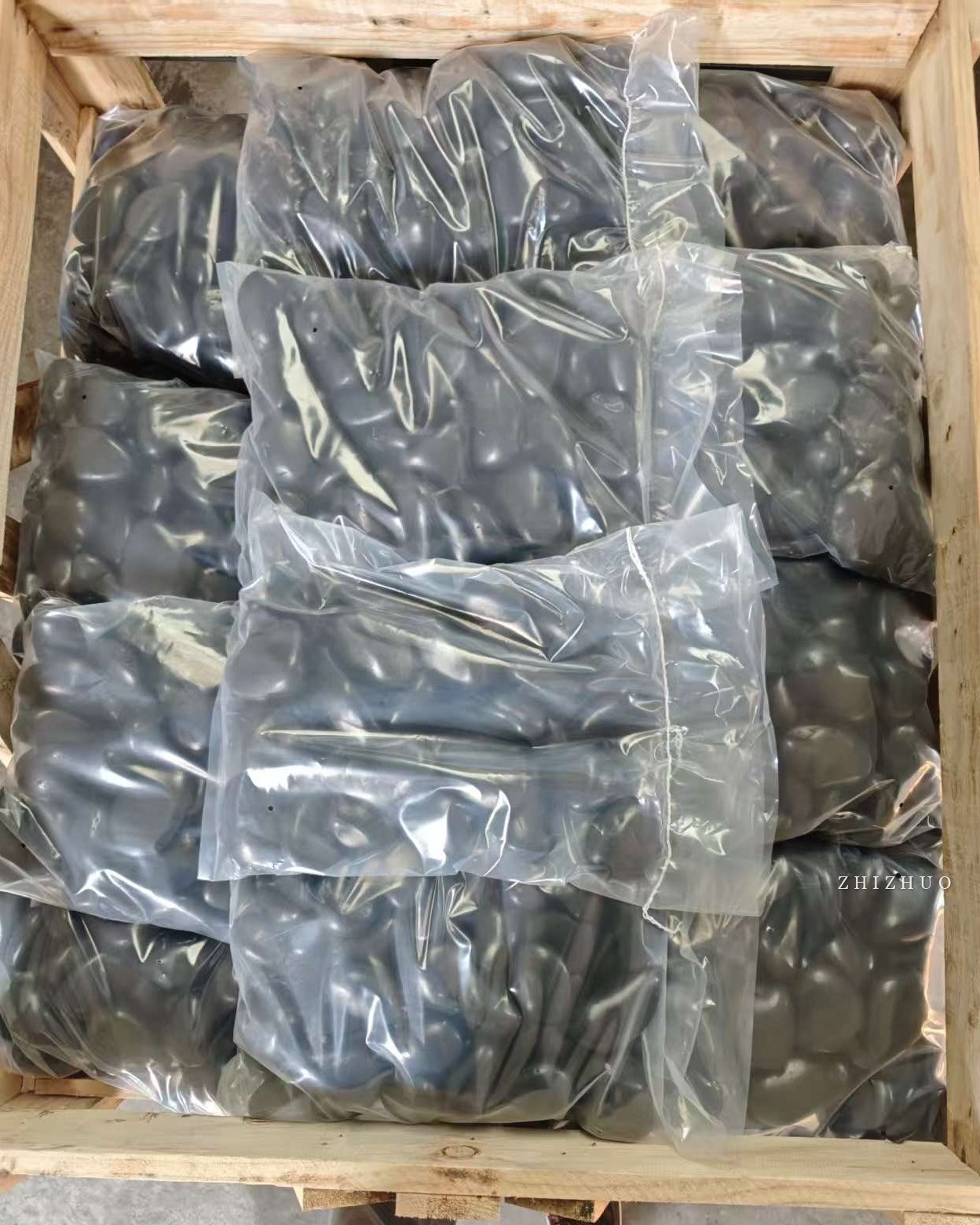 Black polished pebbles packed for export from China