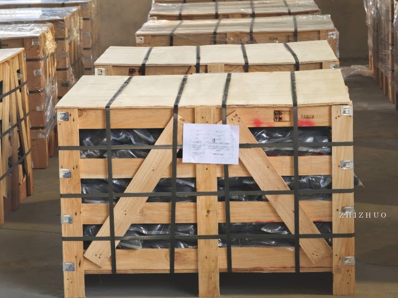 Strapped wooden export crates containing decorative stone in a warehouse